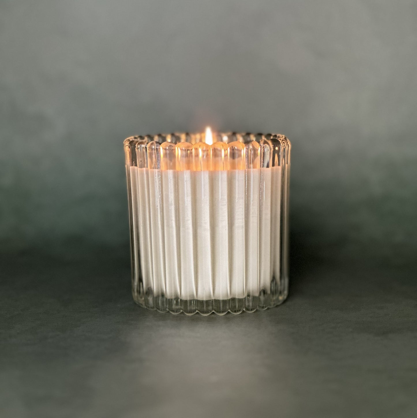 Leveiza candle refill in a clear ribbed glass vessel