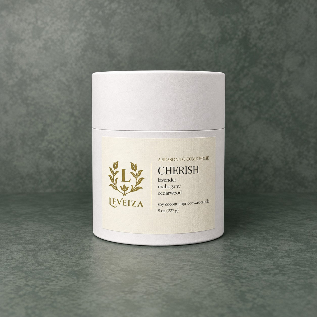 White Leveiza Cherish candle tube with a label listing lavender, mahogany, and cedarwood scent notes