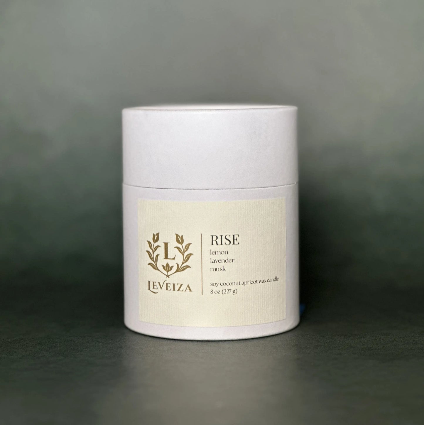 Leveiza Rise candle white tube packaging with lemon lavender musk scent notes