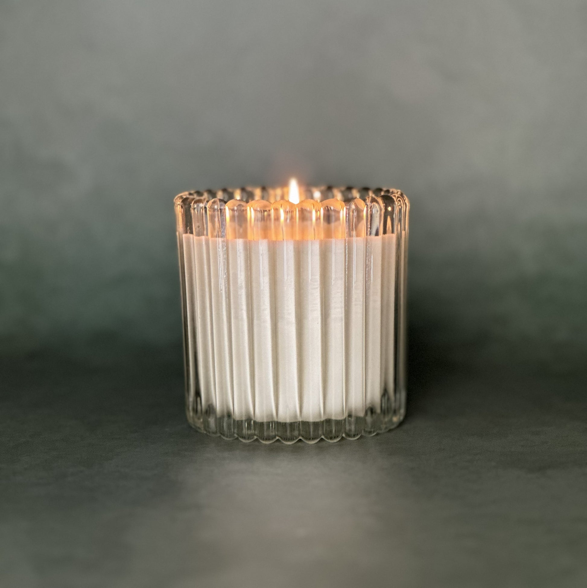 Leveiza candle refill in a clear ribbed glass vessel
