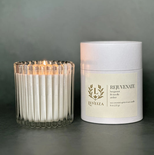 Leveiza Rejuvenate bergamot and fir luxury soy candle in ribbed glass vessel and signature paper tube packaging