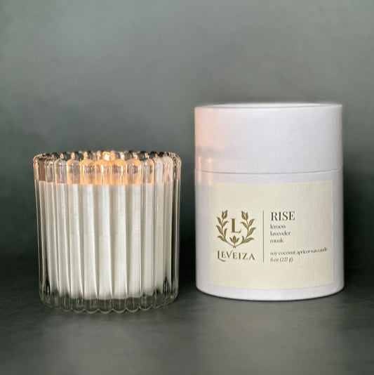 Leveiza Rise white tea and lavender luxury soy candle in ribbed glass vessel and signature paper tube packaging