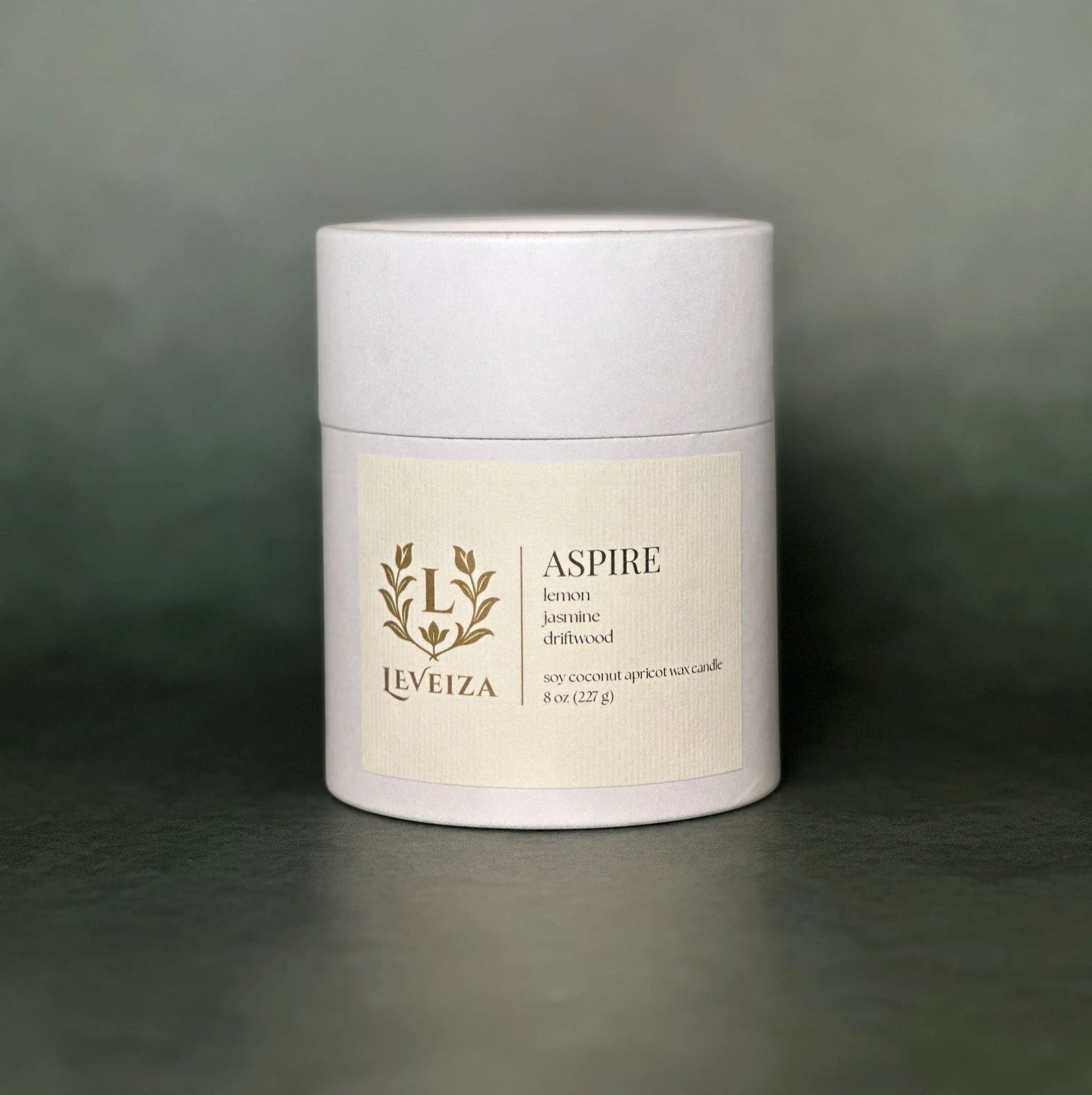 Leveiza Aspire candle white tube packaging with lemon jasmine driftwood scent notes
