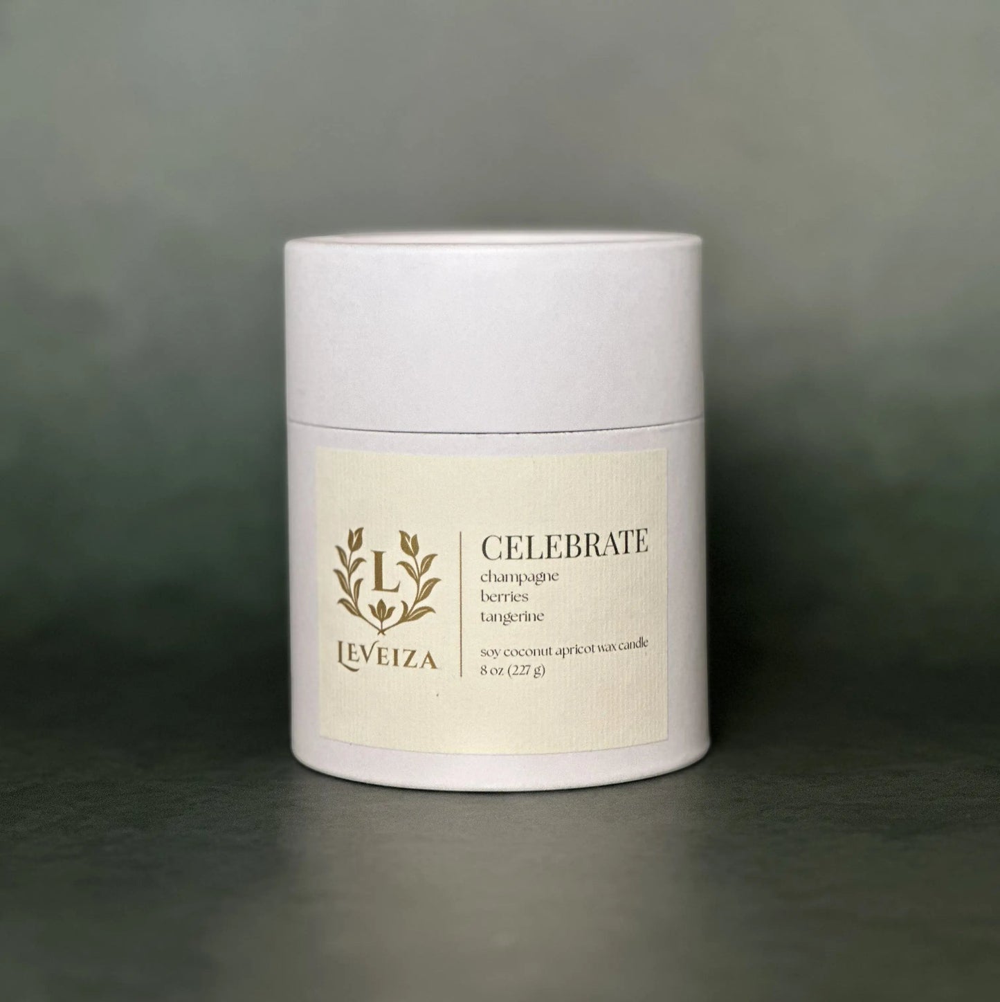 Leveiza Celebrate candle white tube packaging with champagne berries tangerine scent notes