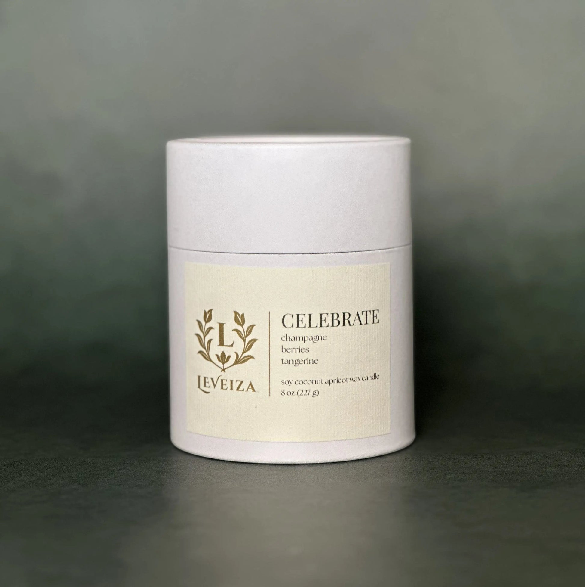 Leveiza Celebrate candle white tube packaging with champagne berries tangerine scent notes