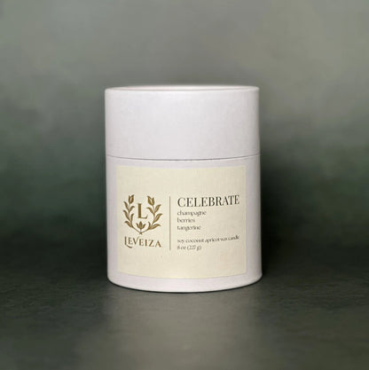 Leveiza Celebrate candle white tube packaging with champagne berries tangerine scent notes