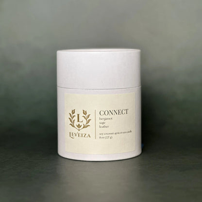 Leveiza Connect candle white tube packaging with bergamot sage leather scent notes