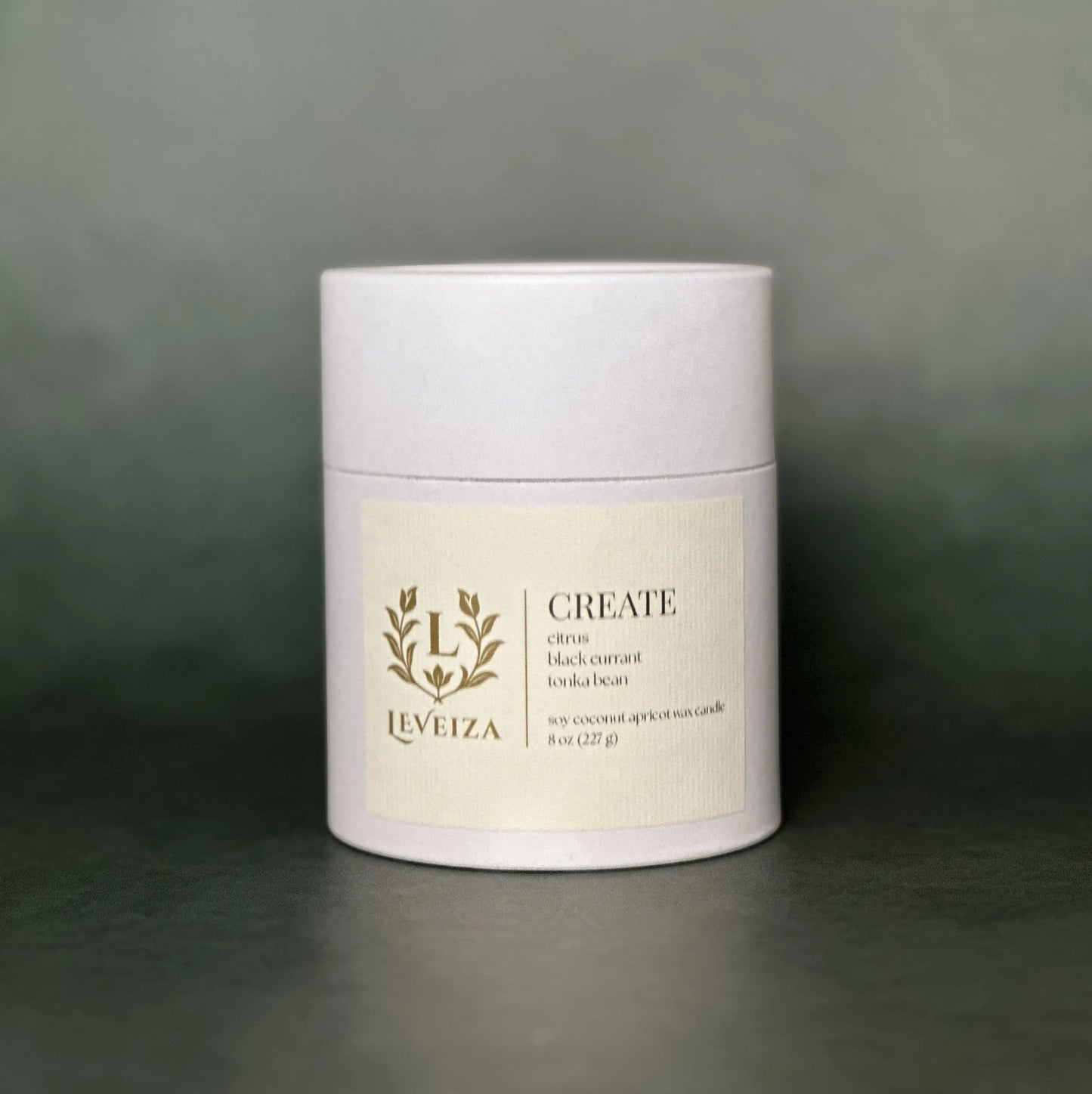 Leveiza Create candle white tube packaging with citrus black currant tonka bean scent notes