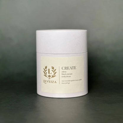Leveiza Create candle white tube packaging with citrus black currant tonka bean scent notes