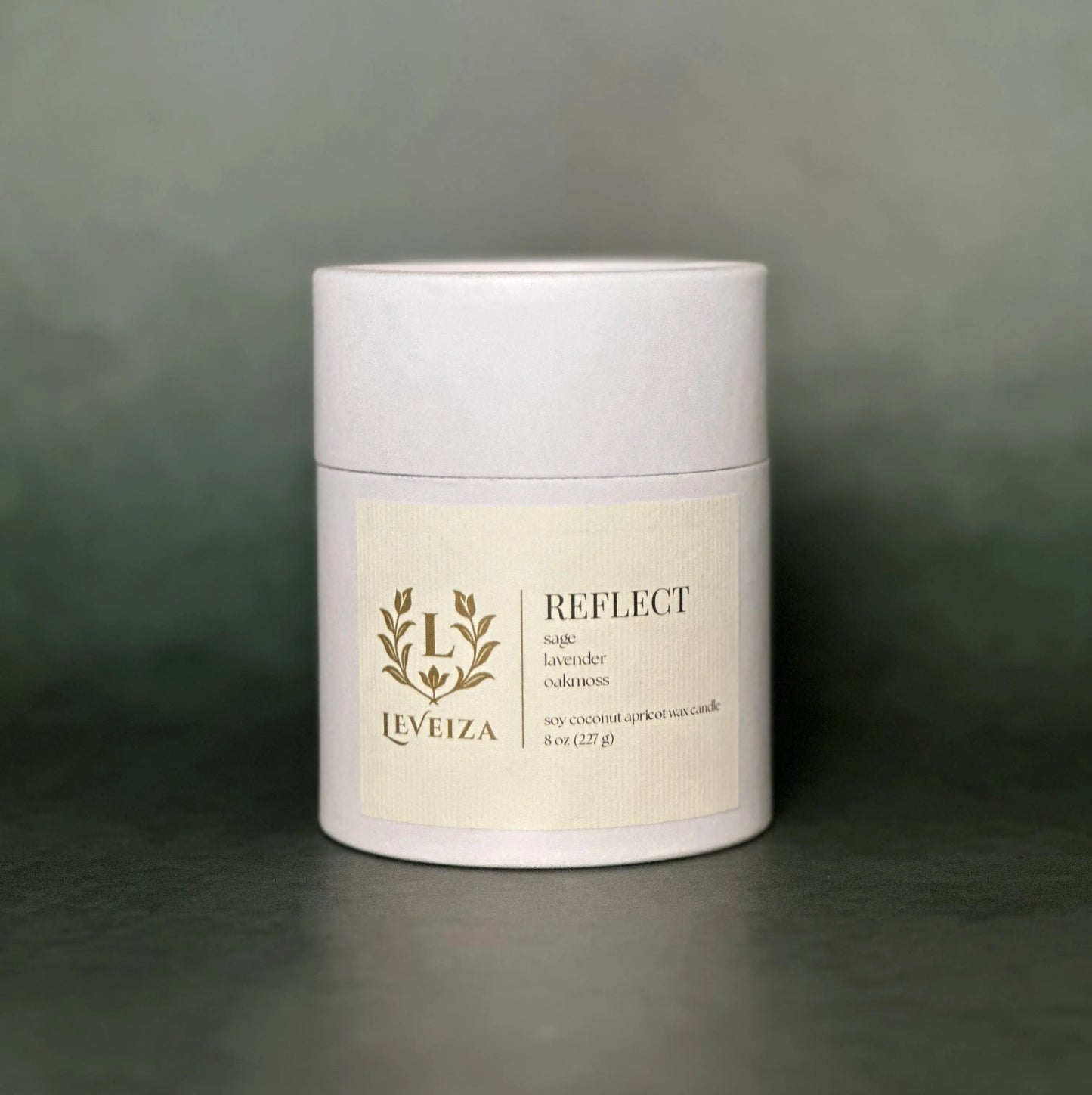 Leveiza Reflect candle white tube packaging with sage lavender oakmoss scent notes