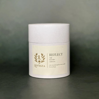 Leveiza Reflect candle white tube packaging with sage lavender oakmoss scent notes