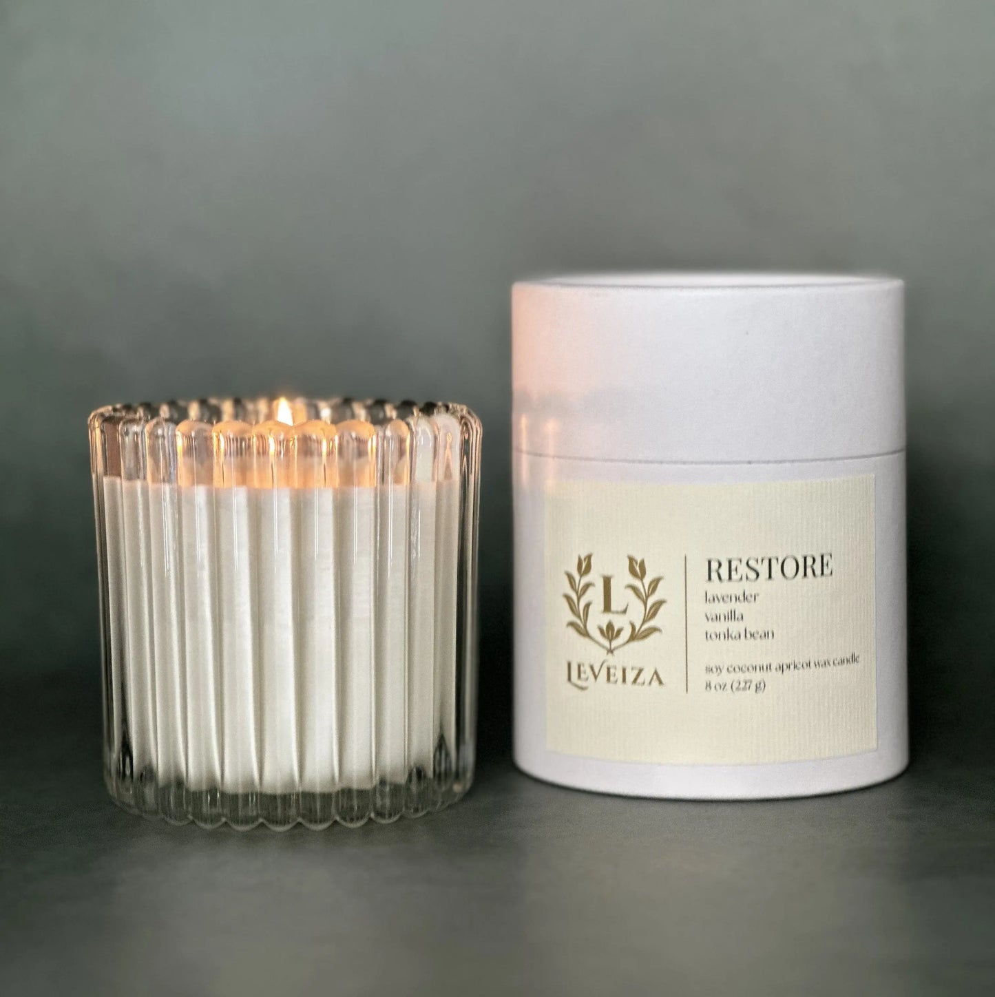 Restore luxury soy candle with white tube packaging by Leveiza