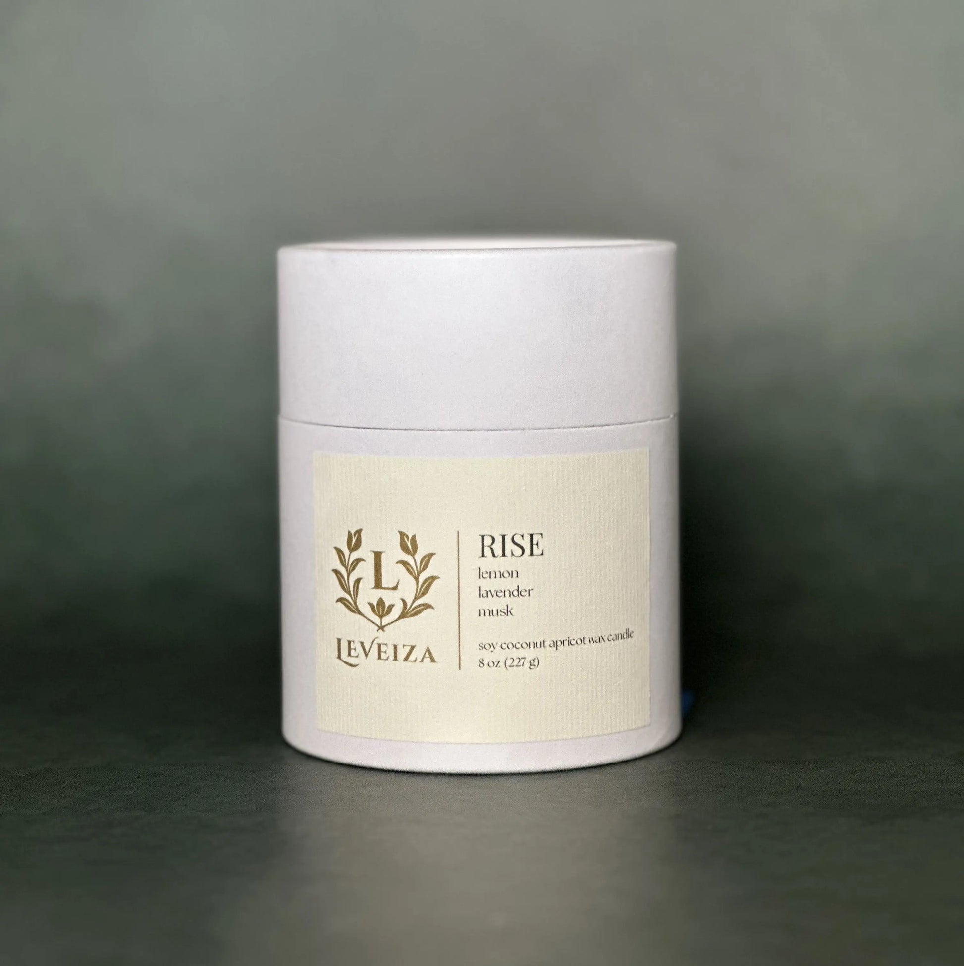Leveiza Rise candle white tube packaging with lemon lavender musk scent notes