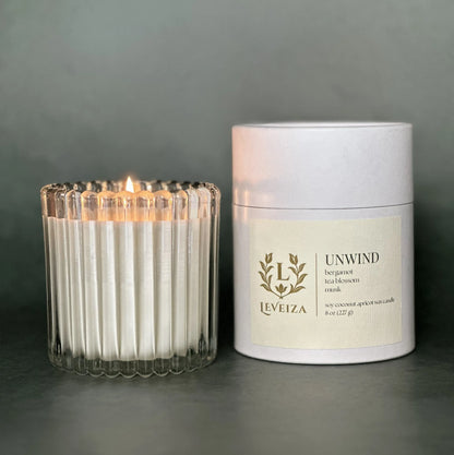 Unwind luxury soy candle with white tube packaging by Leveiza
